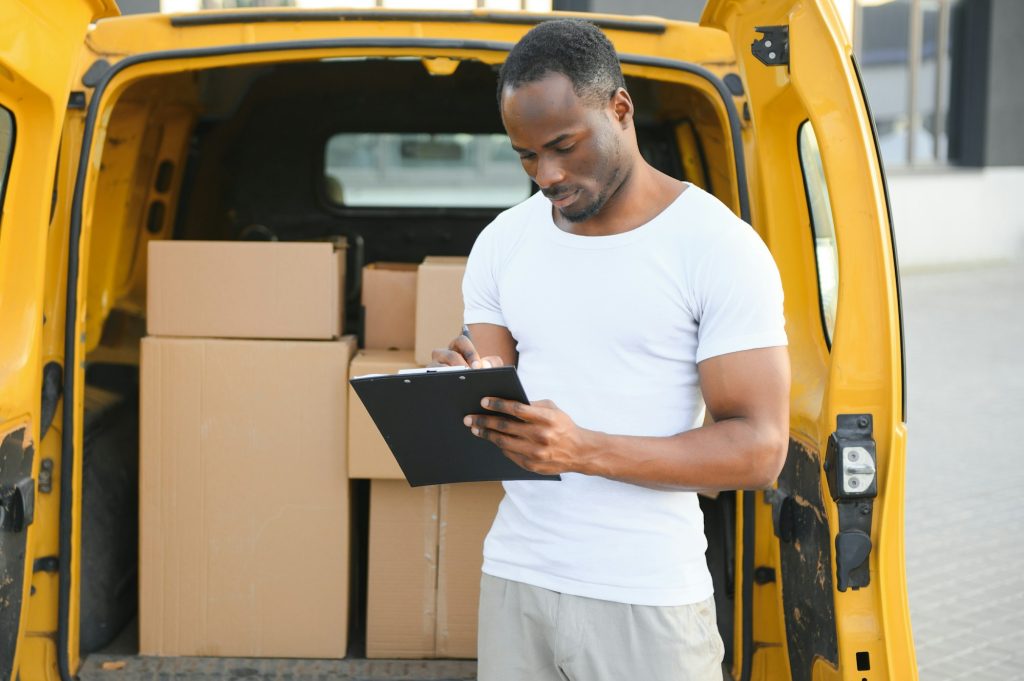 Delivery man near shipping mini van.